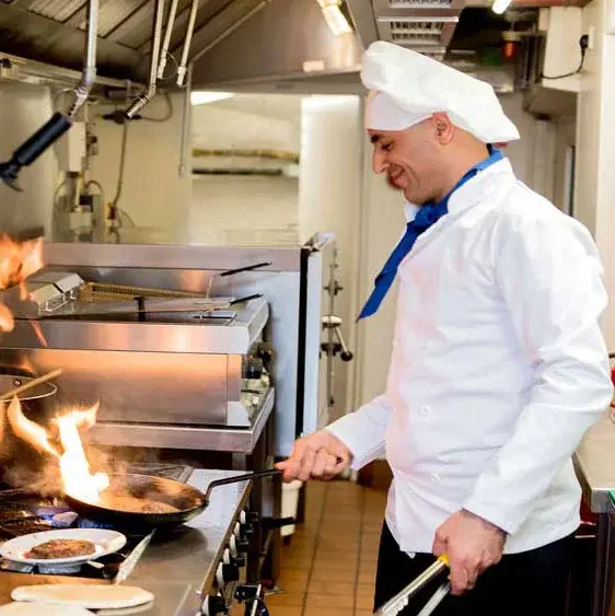 Mountain View Gardens Chef Created Meals, chef frying a dish.