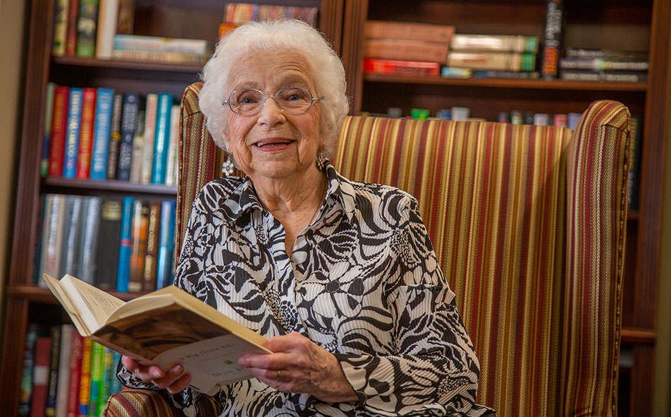 The library at Mountain View Gardens with shelves of books and comfortable seating